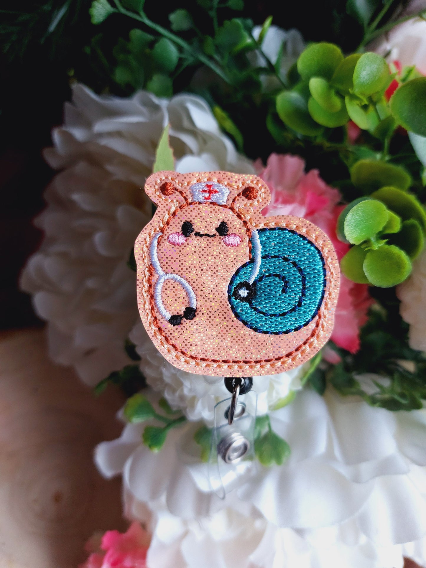 Nurse Snail Plant Badge Reel